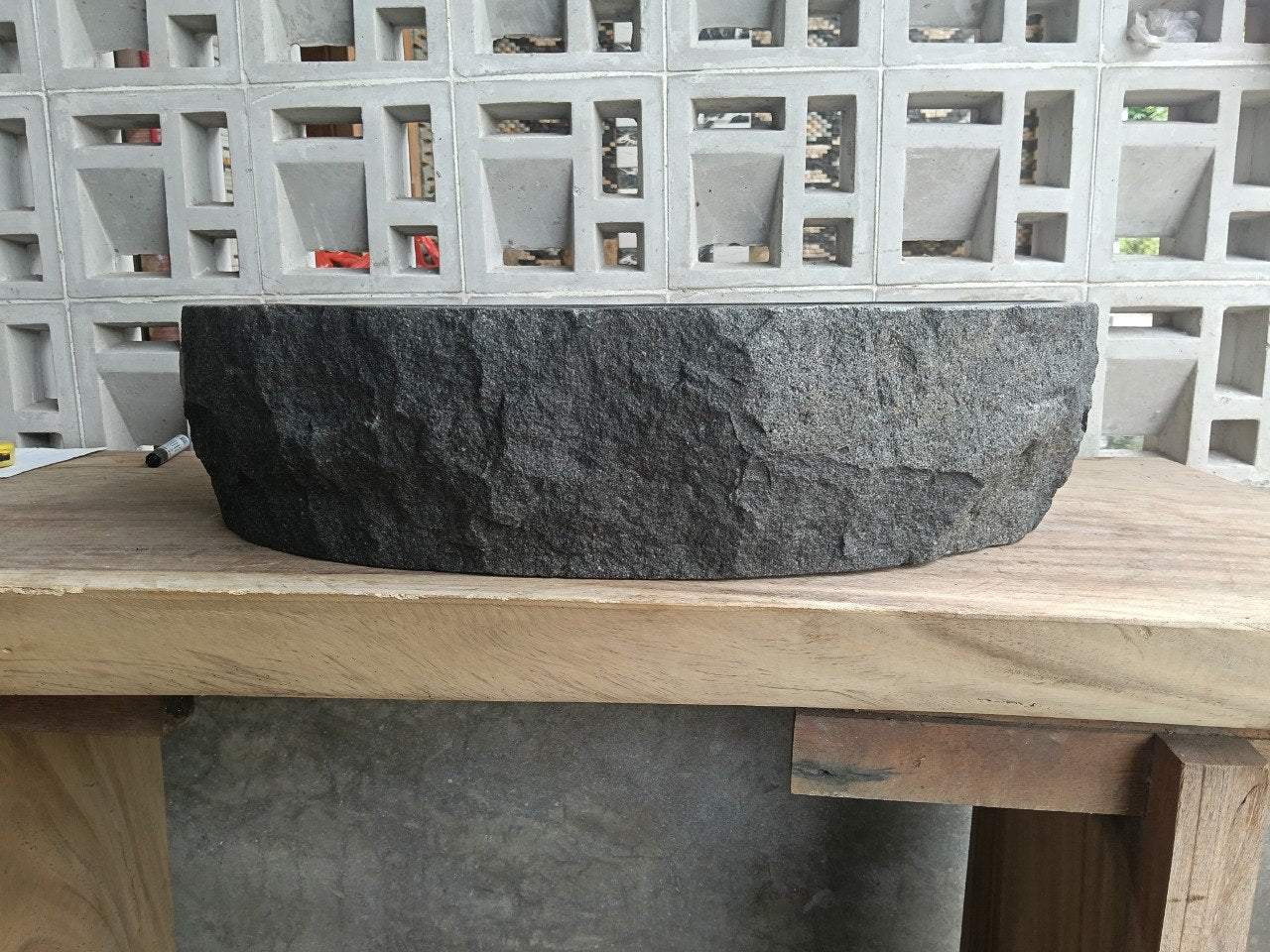 Left side perspective of elongated oval andesite basin polished interior
