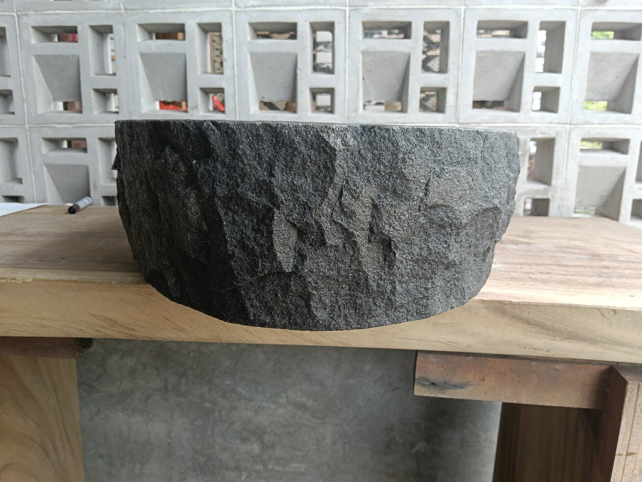 Right side perspective of handcrafted dark gray oval andesite sink
