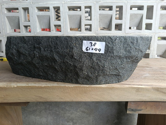 Front view of handcrafted oval andesite bathroom sink with mineral inclusions
