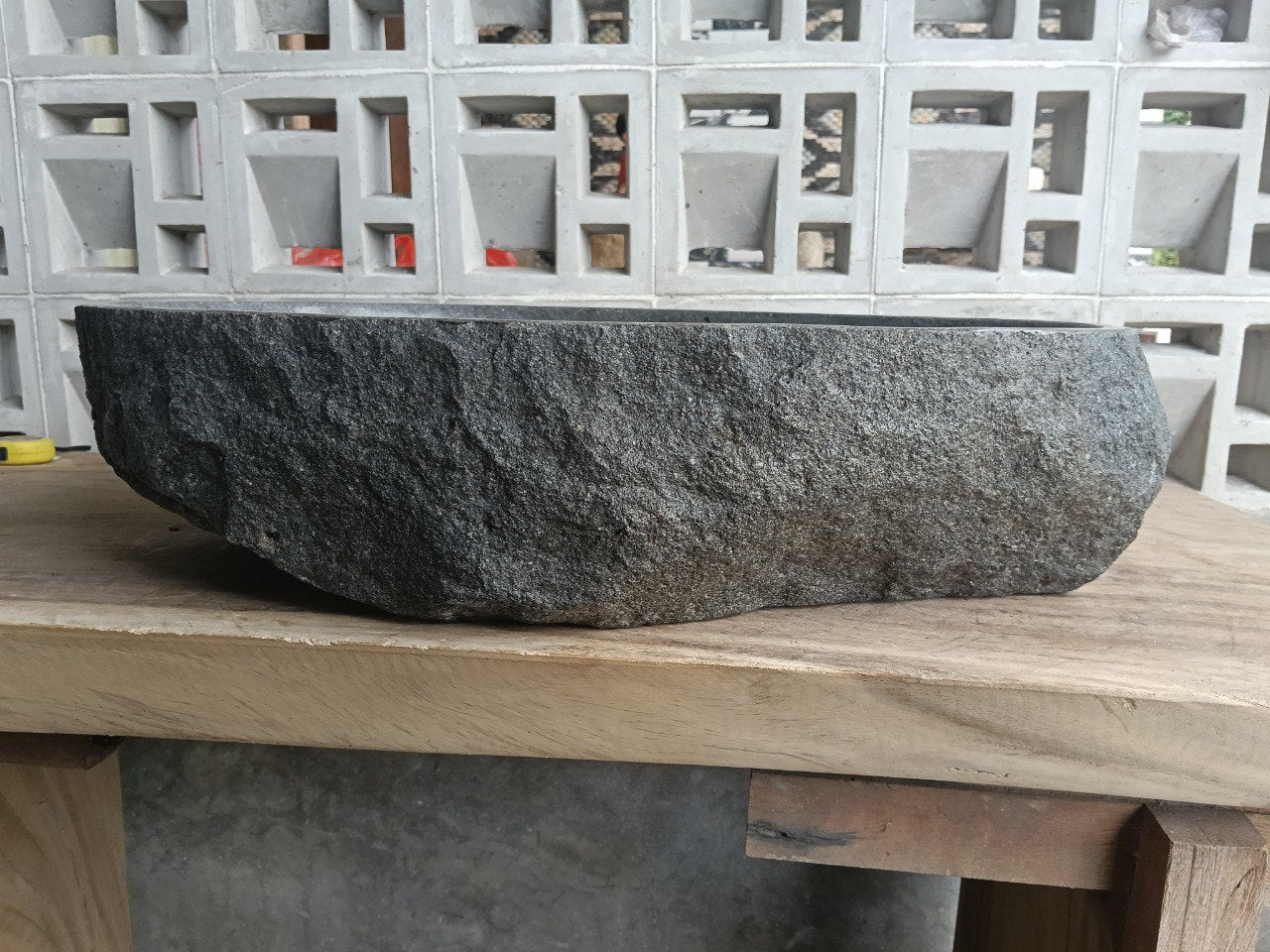 Left side perspective of oval andesite basin polished interior
