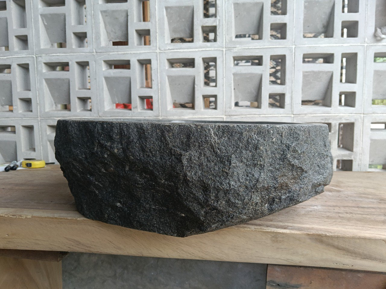 Right side perspective of handcrafted dark gray stone sink
