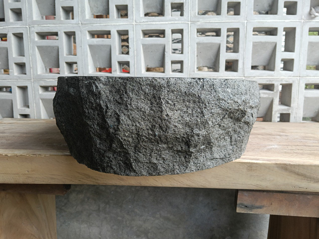 Back view showing split-rock exterior of oval andesite sink
