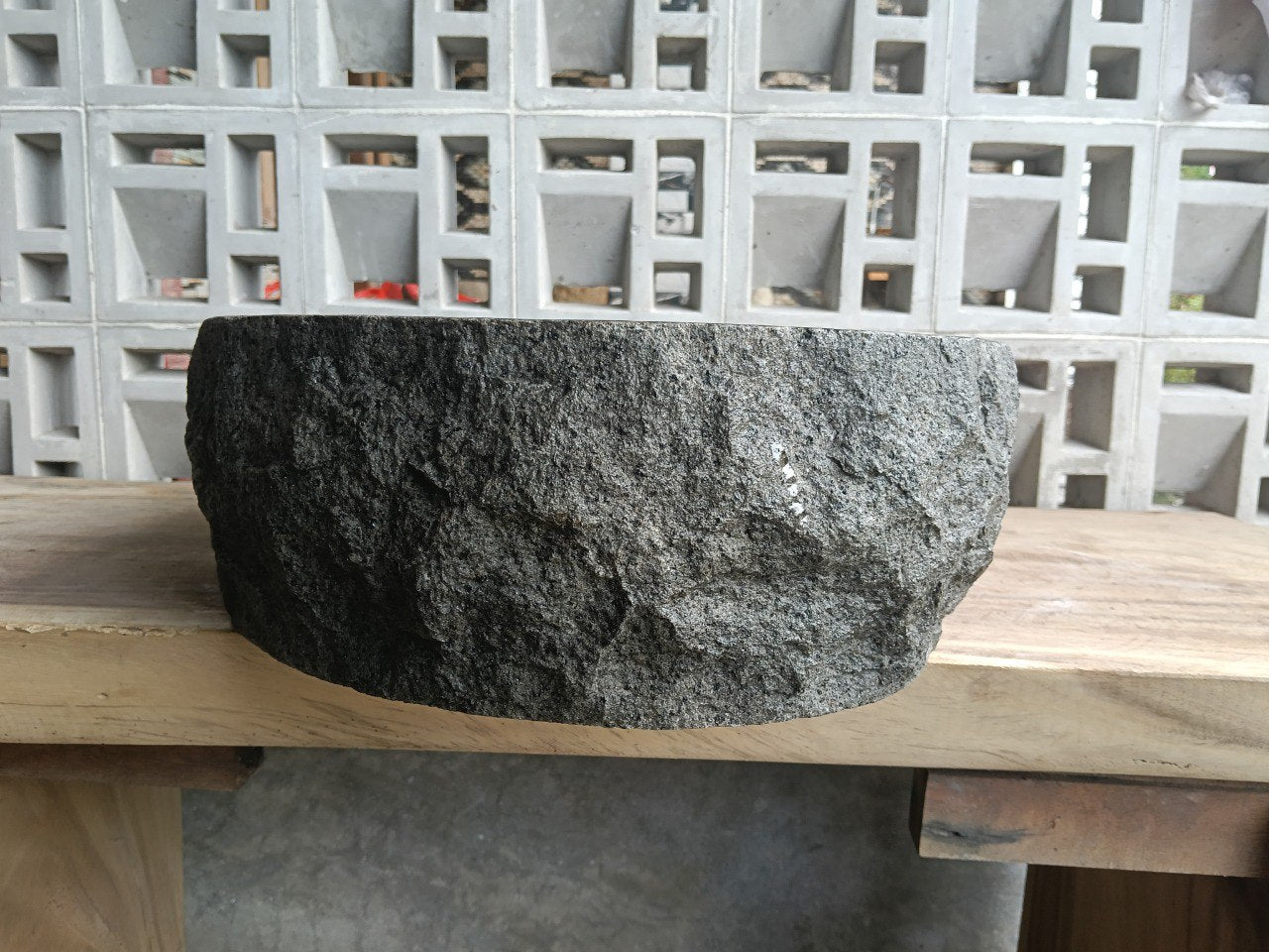 Left side perspective of elongated oval andesite basin polished interior
