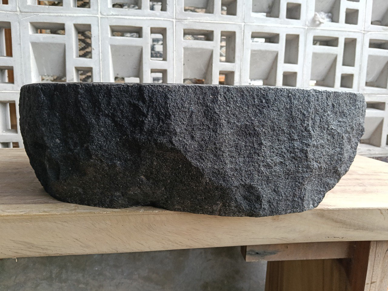 Back view showing split-rock exterior of oval andesite sink
