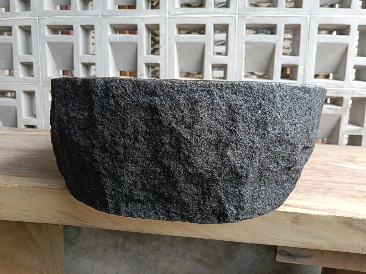 Left side perspective of oval andesite basin polished interior

