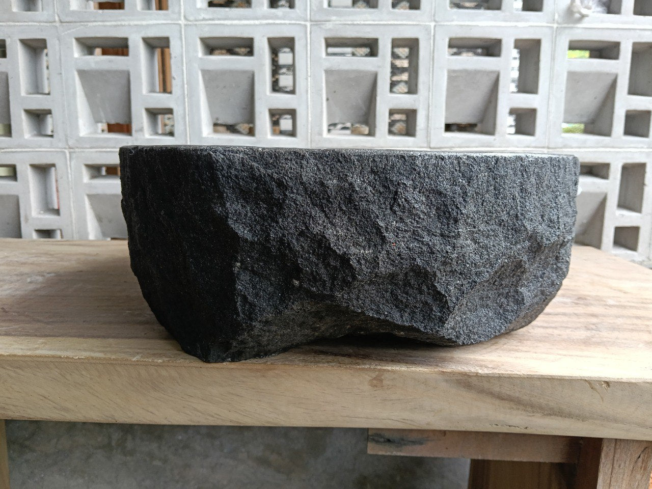 Right side perspective of handcrafted dark gray stone sink
