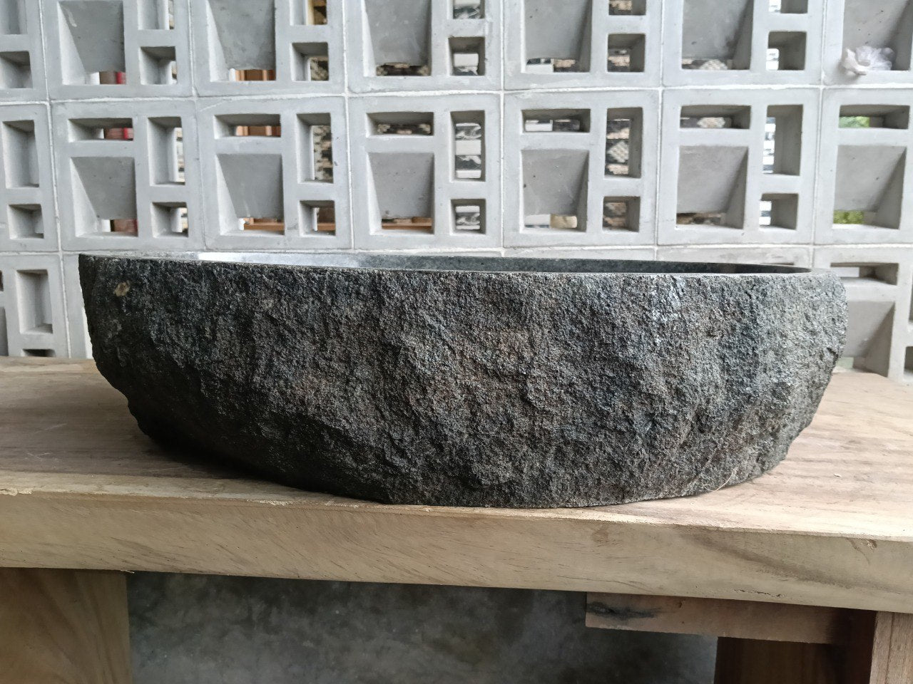 Left side perspective of oval andesite basin polished interior
