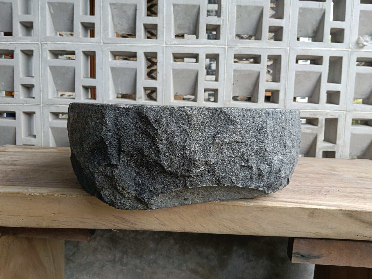 Left side perspective of oval andesite basin polished interior
