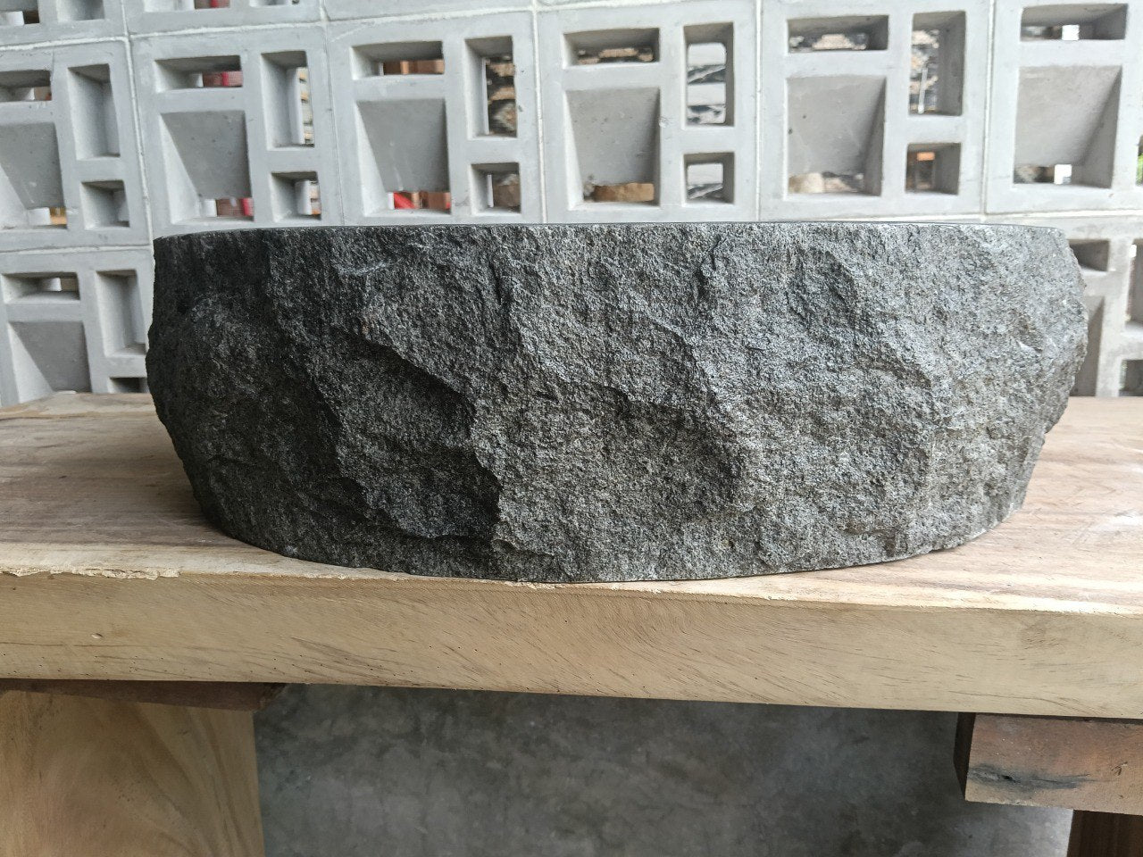 Back view showing split-rock exterior of oval andesite stone sink
