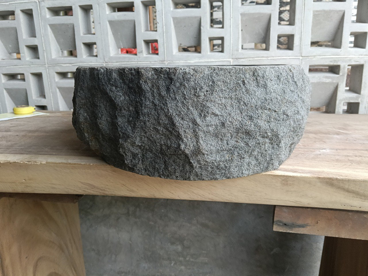 Back view showing split-rock exterior of oval andesite sink
