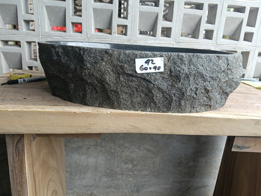 Front view of handcrafted oval andesite bathroom sink with polished finish

