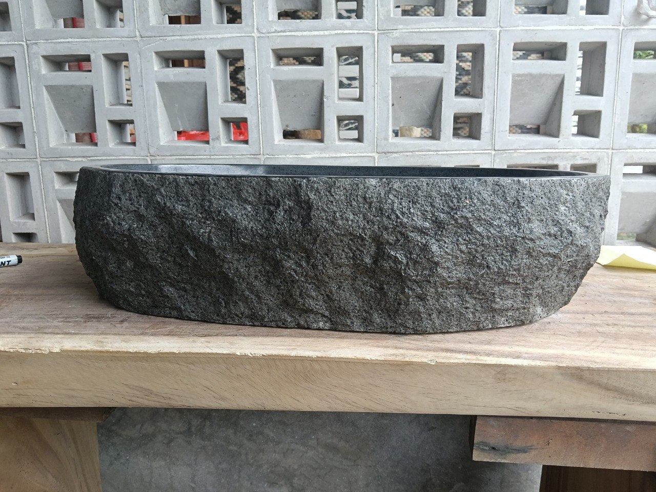 Left side perspective of oval andesite basin polished interior
