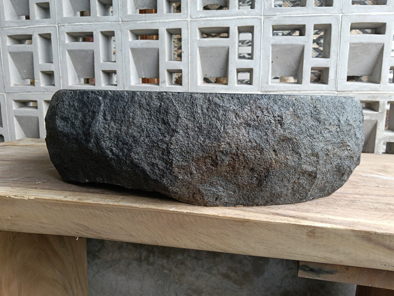 Back view showing split-rock exterior of oval andesite stone sink

