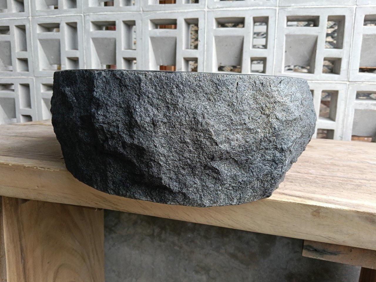 Right side perspective of handcrafted oval dark gray andesite sink
