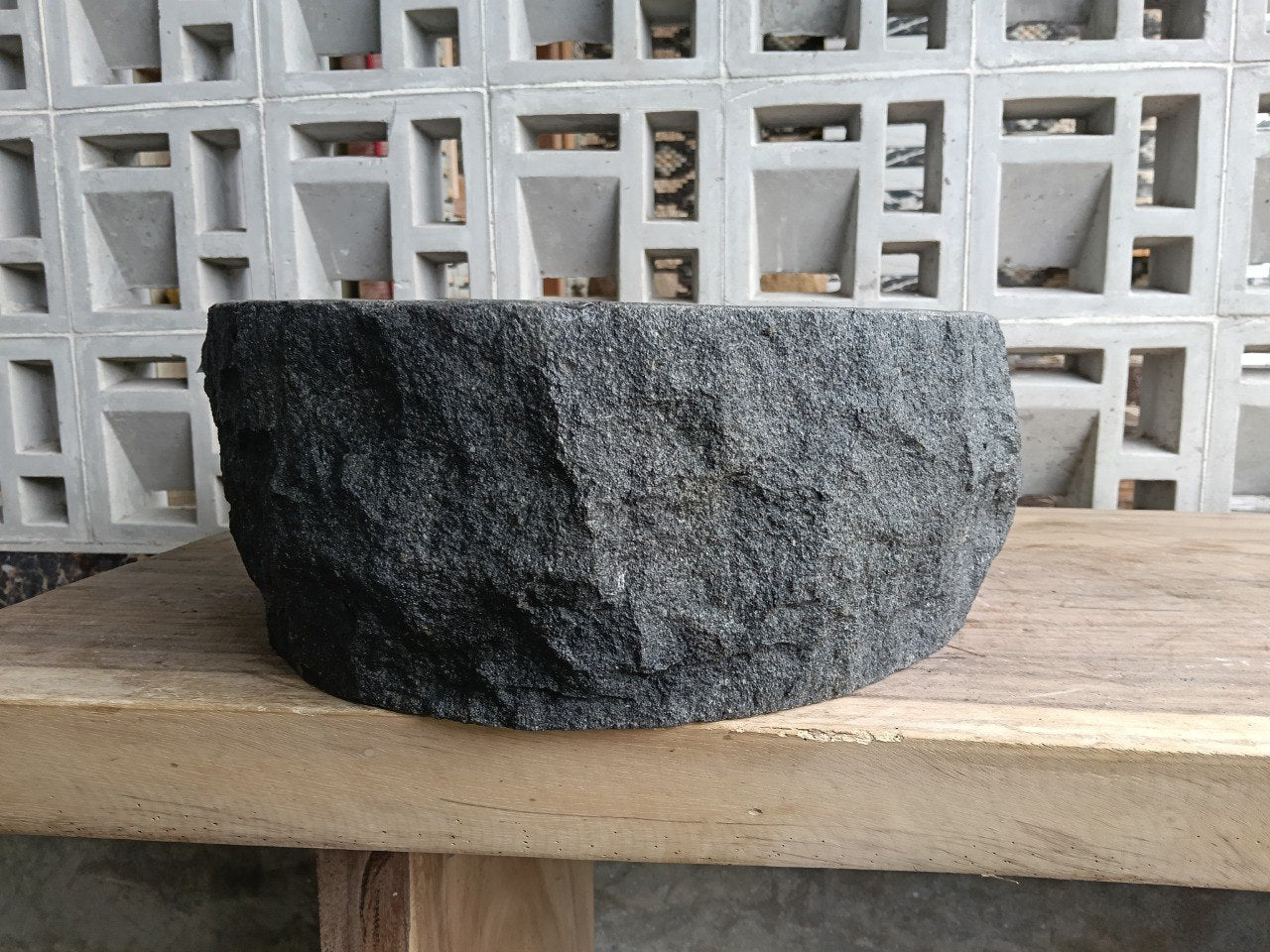 Back view showing split-rock exterior of oval andesite sink
