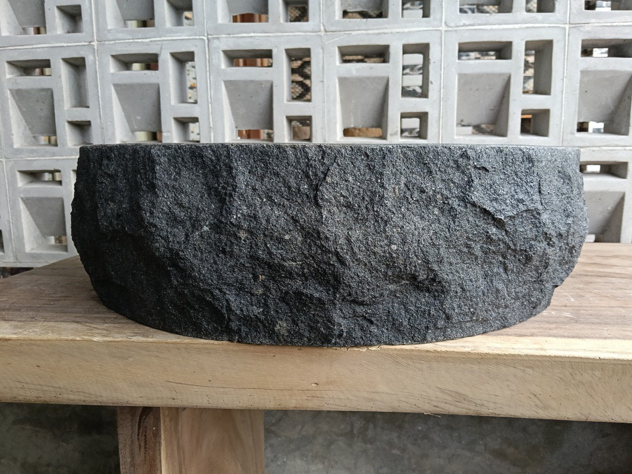 Left side perspective of oval andesite basin polished interior
