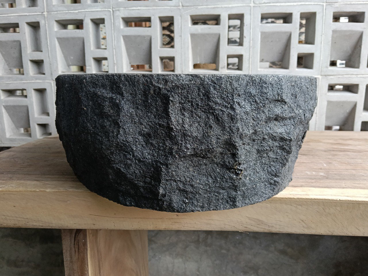 Right side perspective of handcrafted dark gray stone sink
