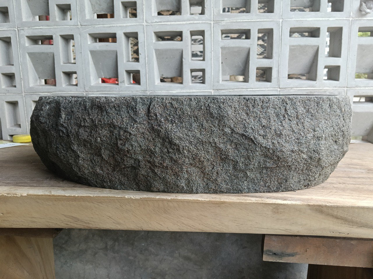 Left side perspective of oval andesite basin polished interior
