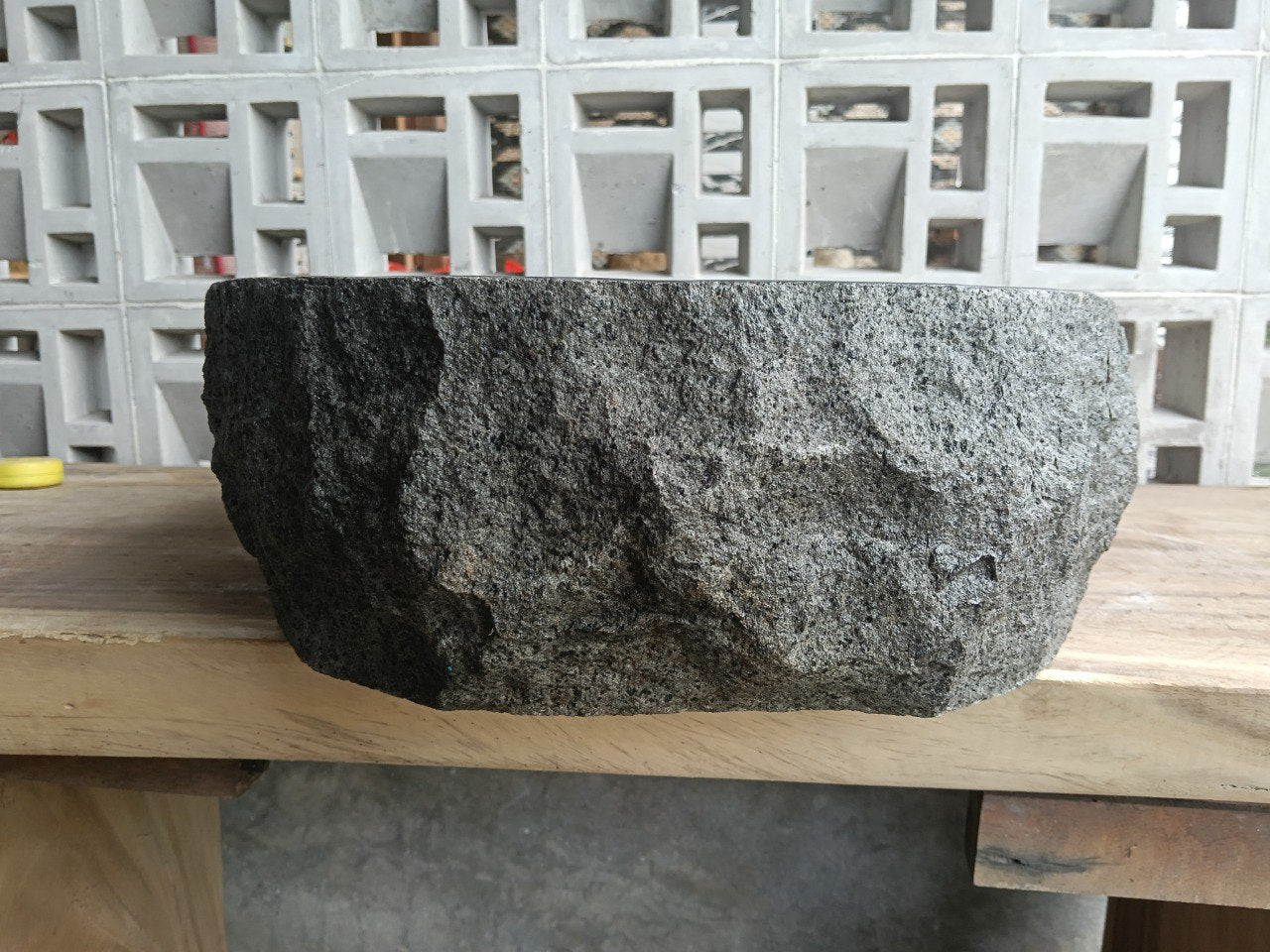 Back view showing split-rock exterior of elongated oval andesite sink
