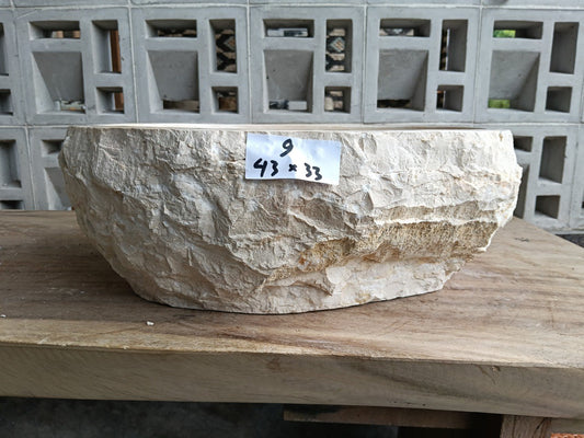 Front view of handcrafted oval beige marble bathroom sink
