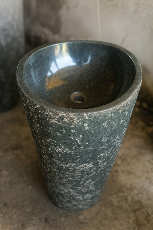 Polished interior bowl of tall freestanding andesite pedestal sink
