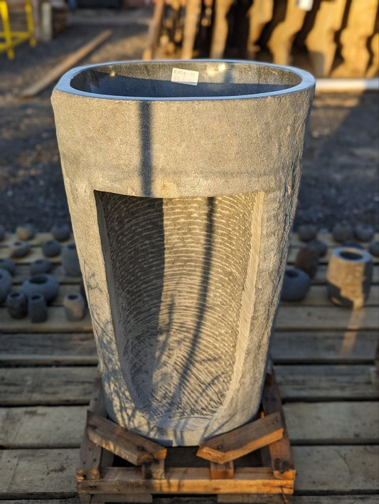 Polished interior bowl of freestanding river stone pedestal sink
