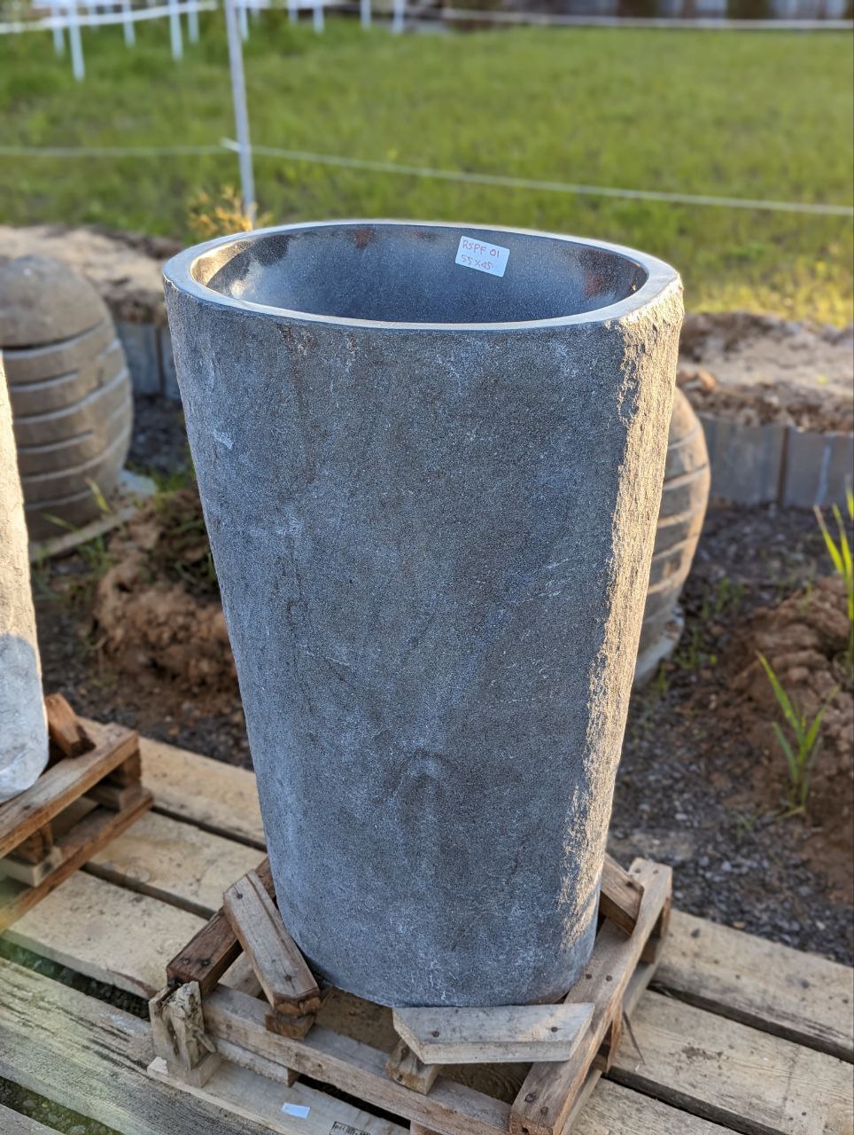 Close-up of rough natural stone finish on pedestal sink
