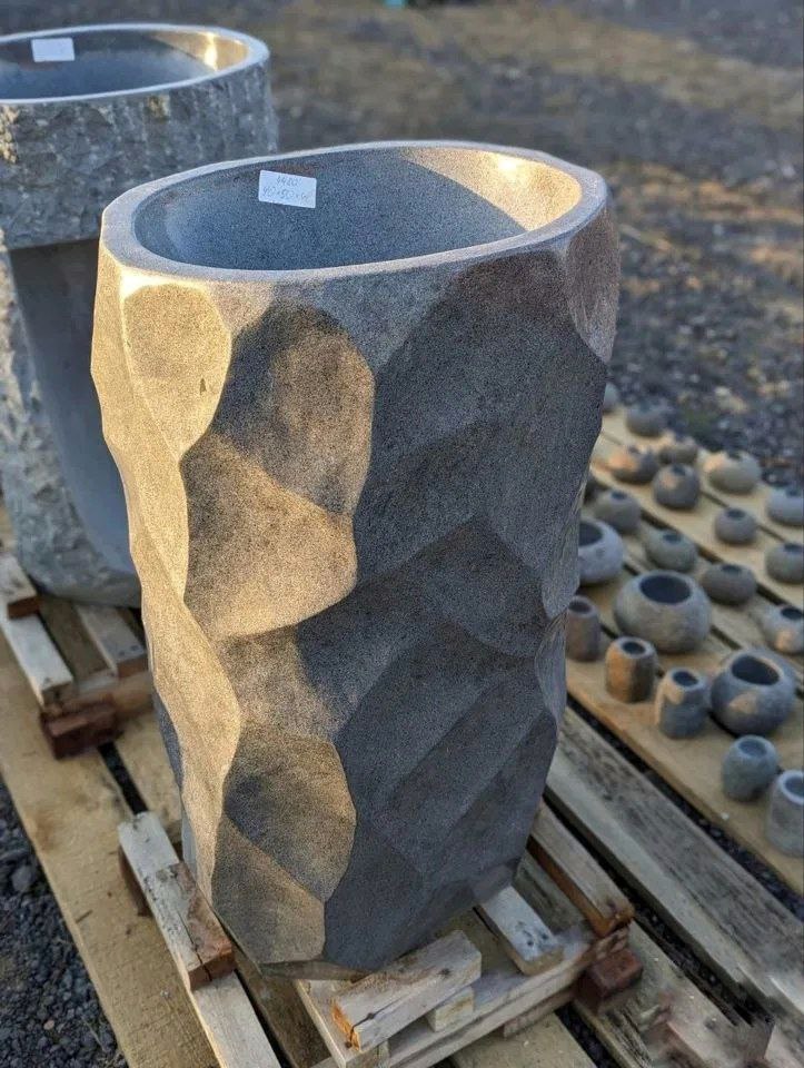 Polished interior bowl of freestanding river stone pedestal sink
