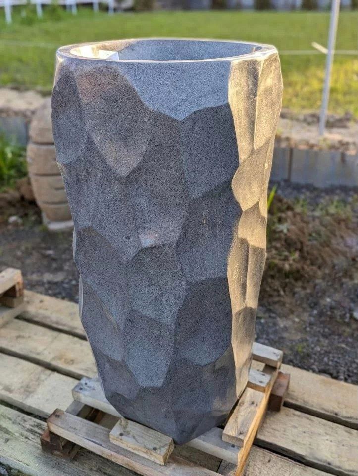 Side angle showing faceted stone texture on pedestal sink
