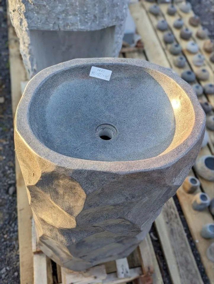 Close-up of sculpted geometric stone finish on pedestal sink
