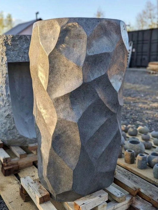 Front view of textured and polished river stone pedestal sink
