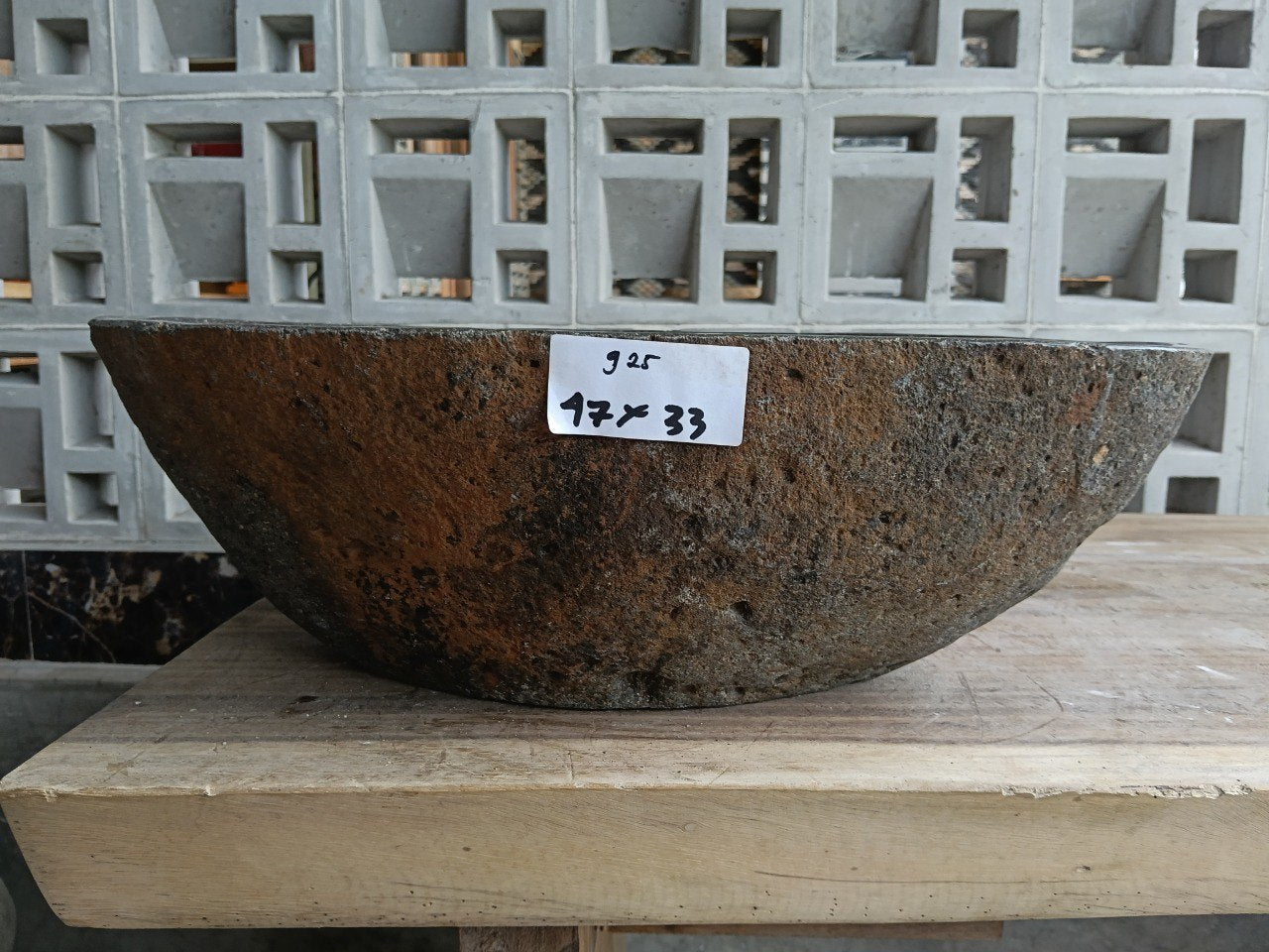 Front view of 6925-4733 natural river rock vessel sink with brown-oxide exterior
