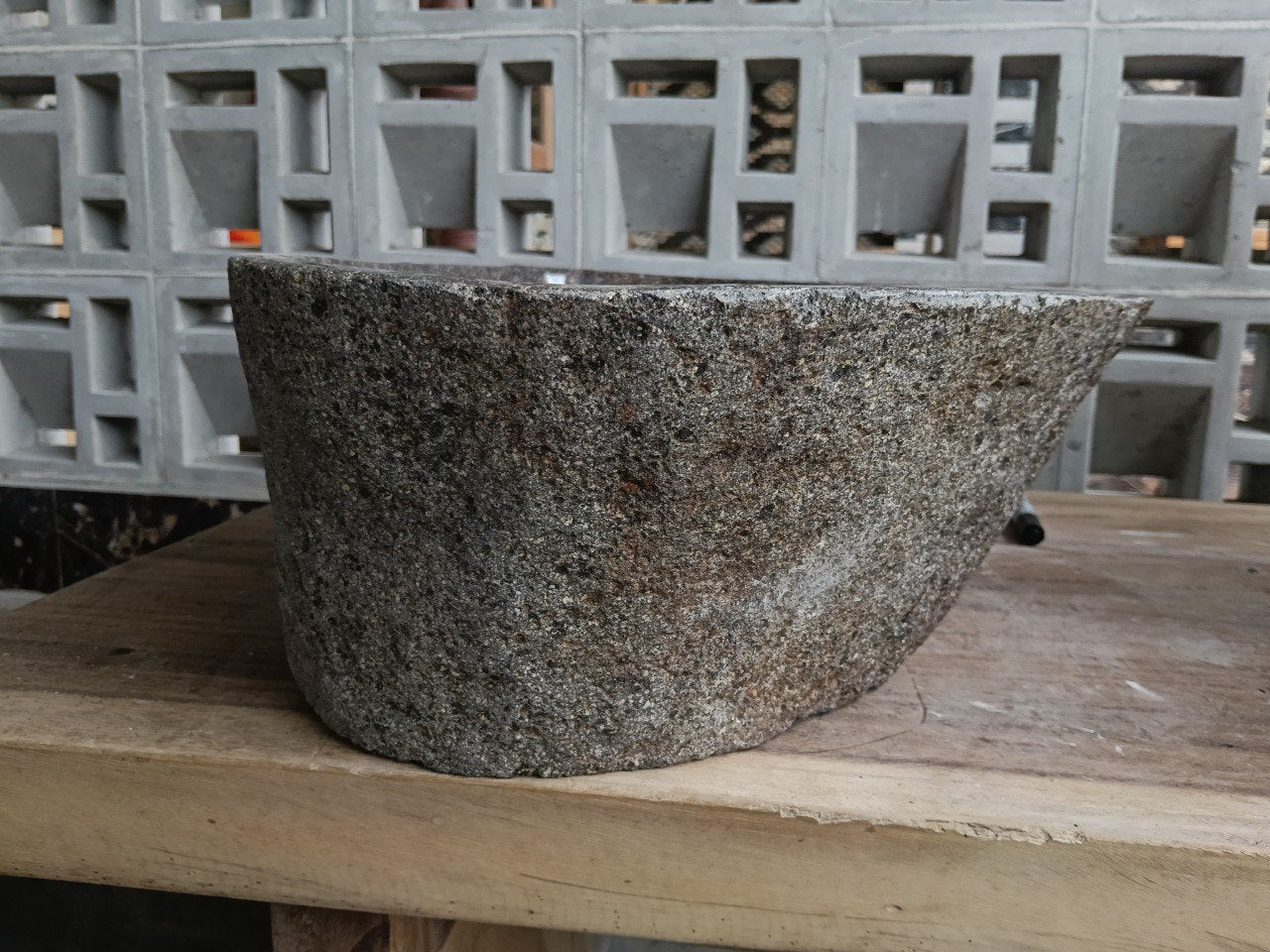 Left side of 6931-4735 river stone sink, tapered wall and polished interior
