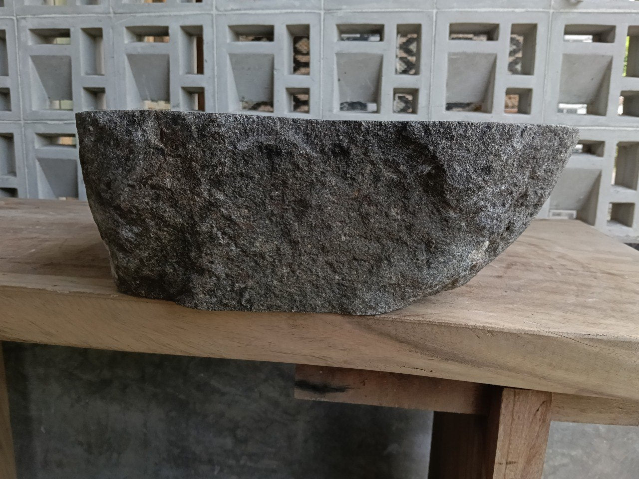 Left side of 6951-4540 river stone sink, dark polished bowl and gray textured surface
