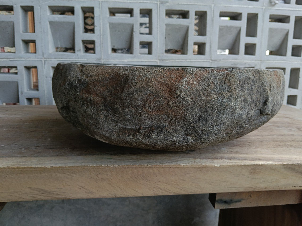 Left side of 6952-4843 river stone sink, dark polished bowl and gray-brown exterior
