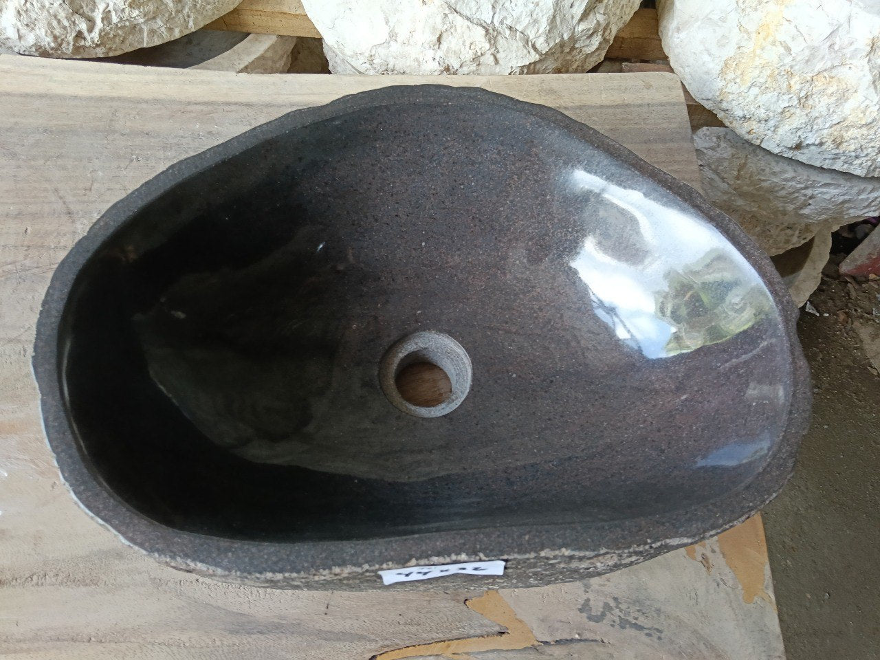 Top view of 6961-4432 faceted river stone sink with polished dark interior
