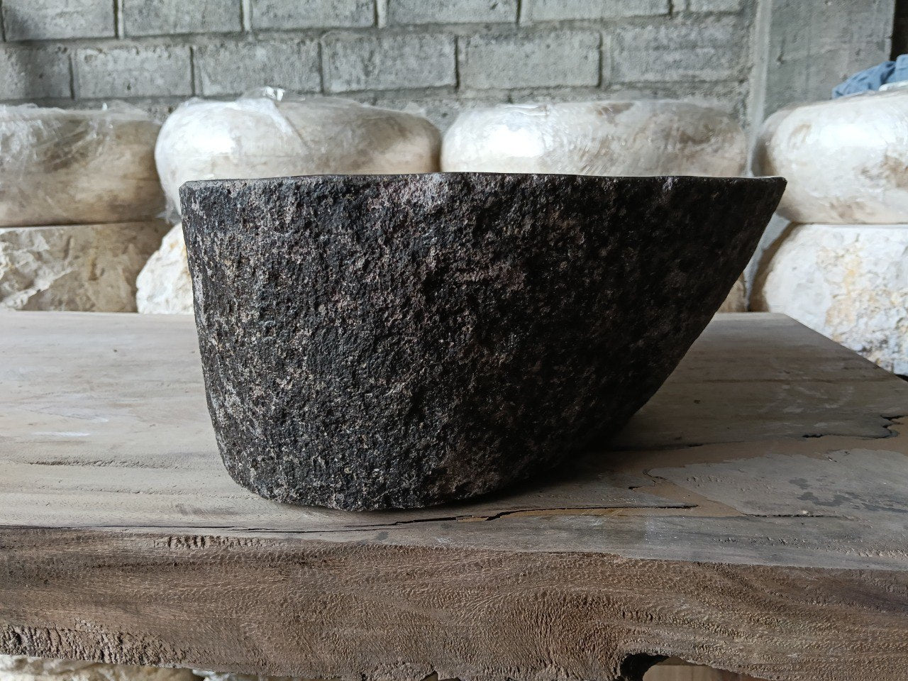 Left side of 6961-4432 faceted river rock sink, dark polished bowl
