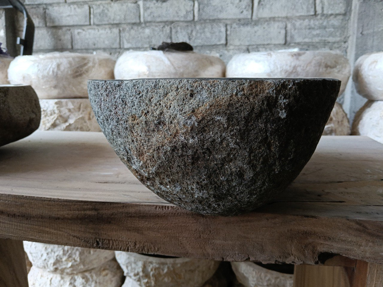 Left side of 6971-4835 river stone vessel sink in gray-brown natural rock
