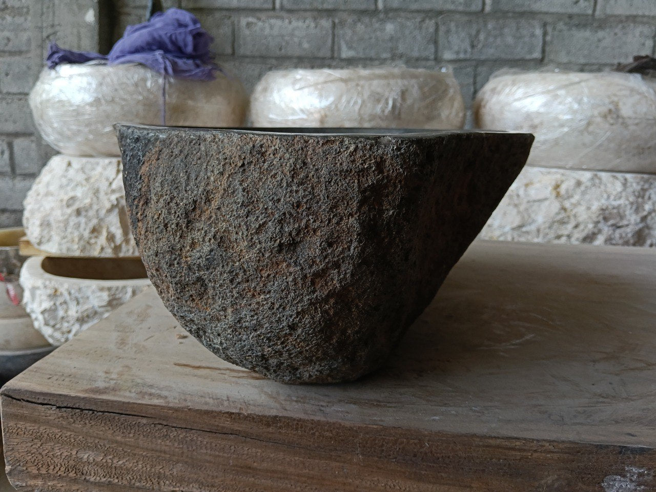 Right side of 6980-4632 natural stone vessel sink, polished interior and raw exterior

