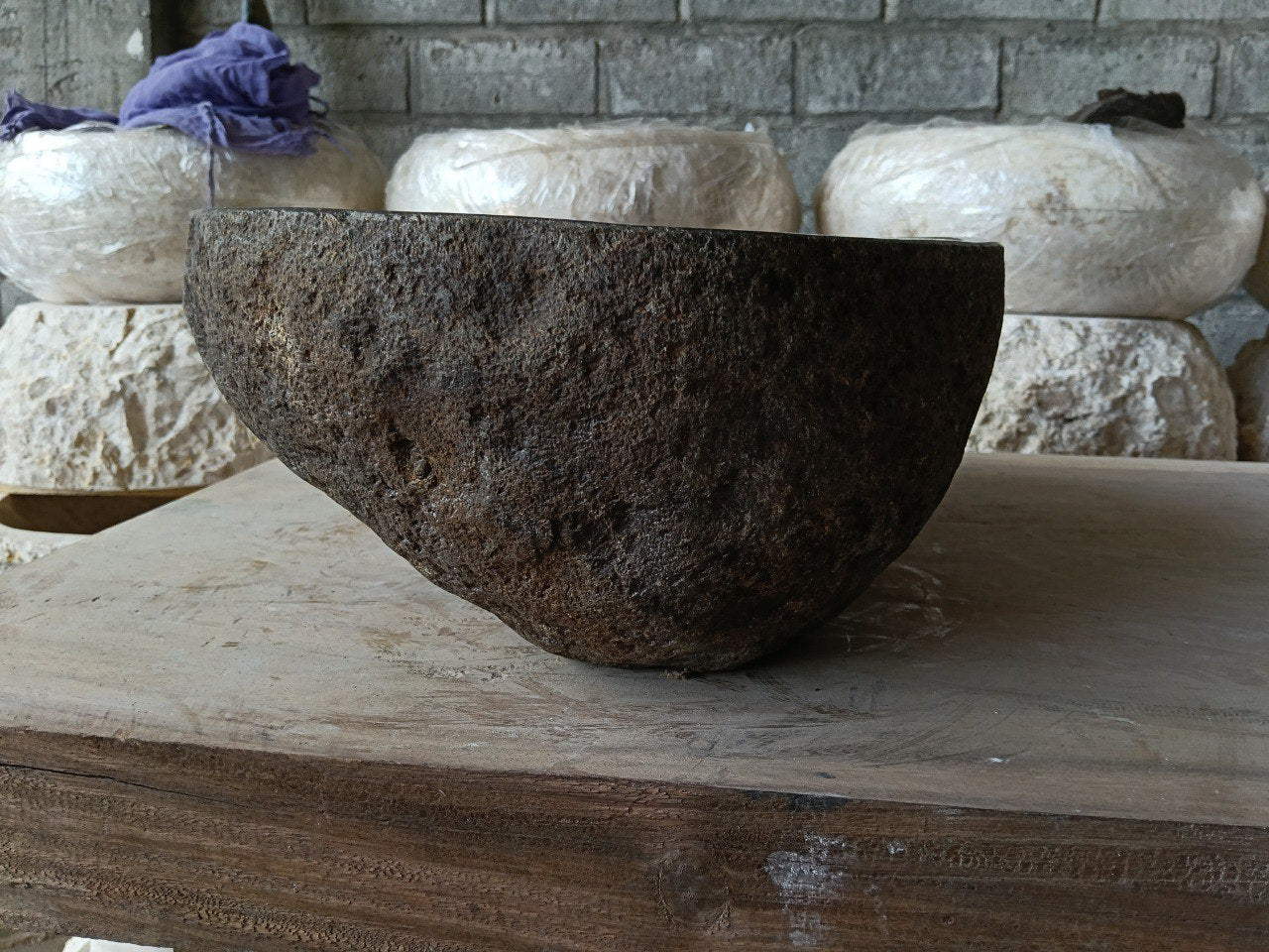 Back view of 6980-4632 handcrafted stone bathroom basin with asymmetrical oval shape
