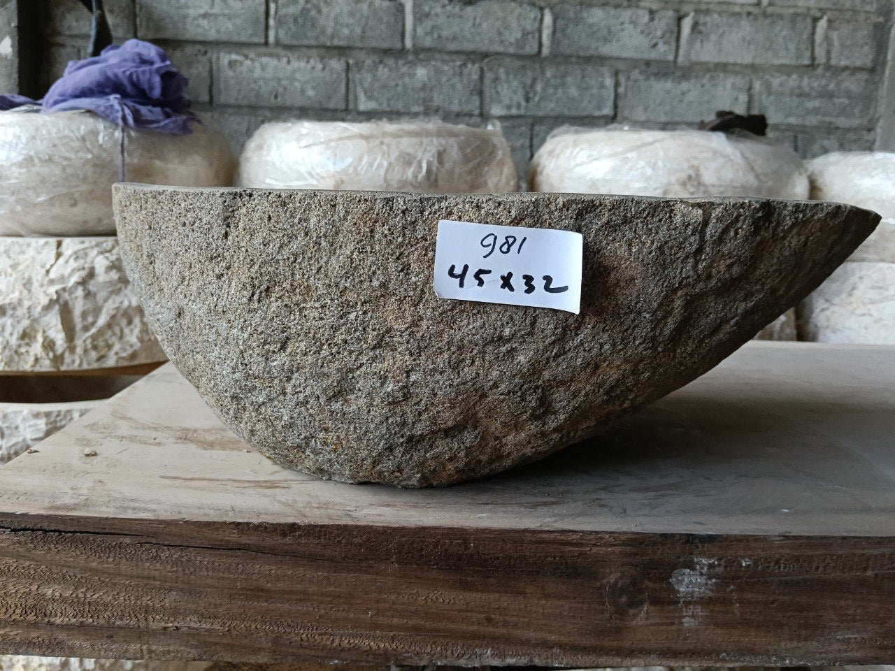 Back view of 6981-4532 handcrafted stone bathroom basin with asymmetrical oval shape
