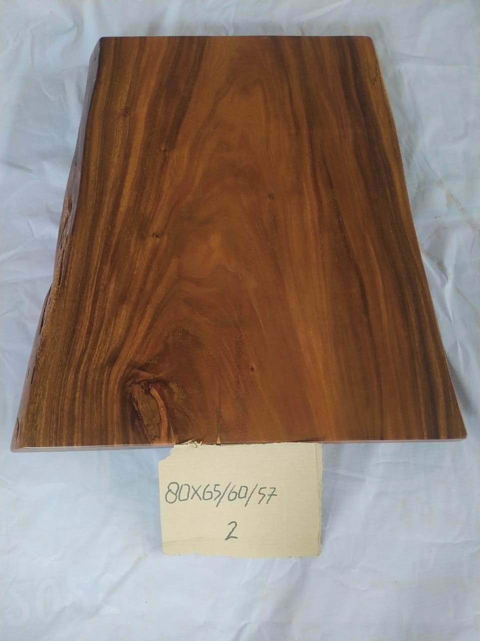 Top view of suar wood slab 0002-576065 with live edge shape and natural brown wood grain, solid single-piece countertop.
