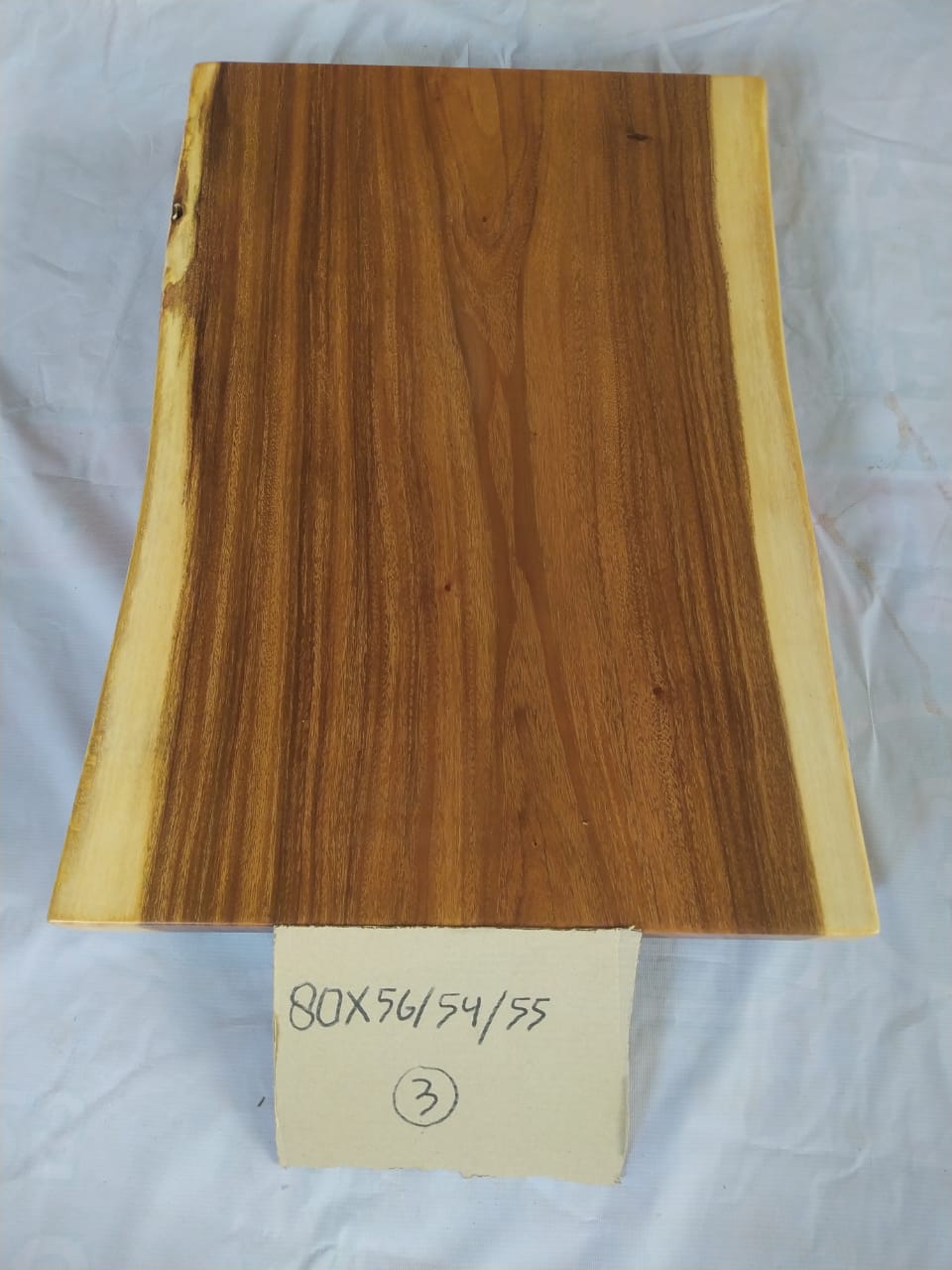 Top view of suar wood slab 0003-565455 with live edge profile and rich brown natural wood grain, single-piece countertop.
