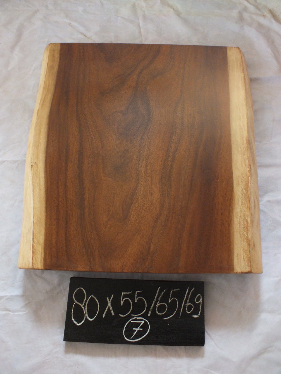 Top view of suar wood slab 0007-556568 with live edge shape and rich natural brown wood grain, solid single-piece countertop.
