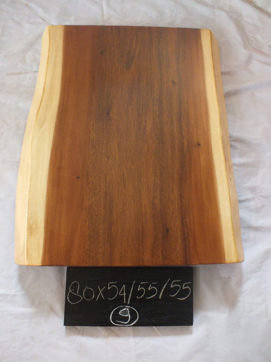 Top view of suar wood slab 0009-545555 with live edge shape and warm brown natural wood grain, solid single-piece countertop.
