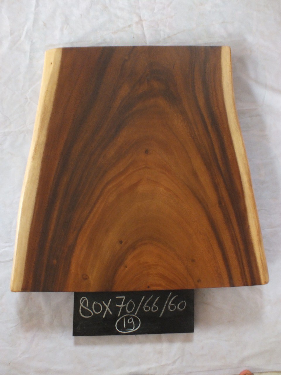 Top view of suar wood slab 0019-706660 with wide live edge shape and rich brown natural wood grain, solid single-piece countertop.
