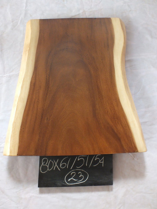 Top view of suar wood slab 0023-615154 with live edge shape and warm brown natural wood grain, organic tapered single-piece countertop.
