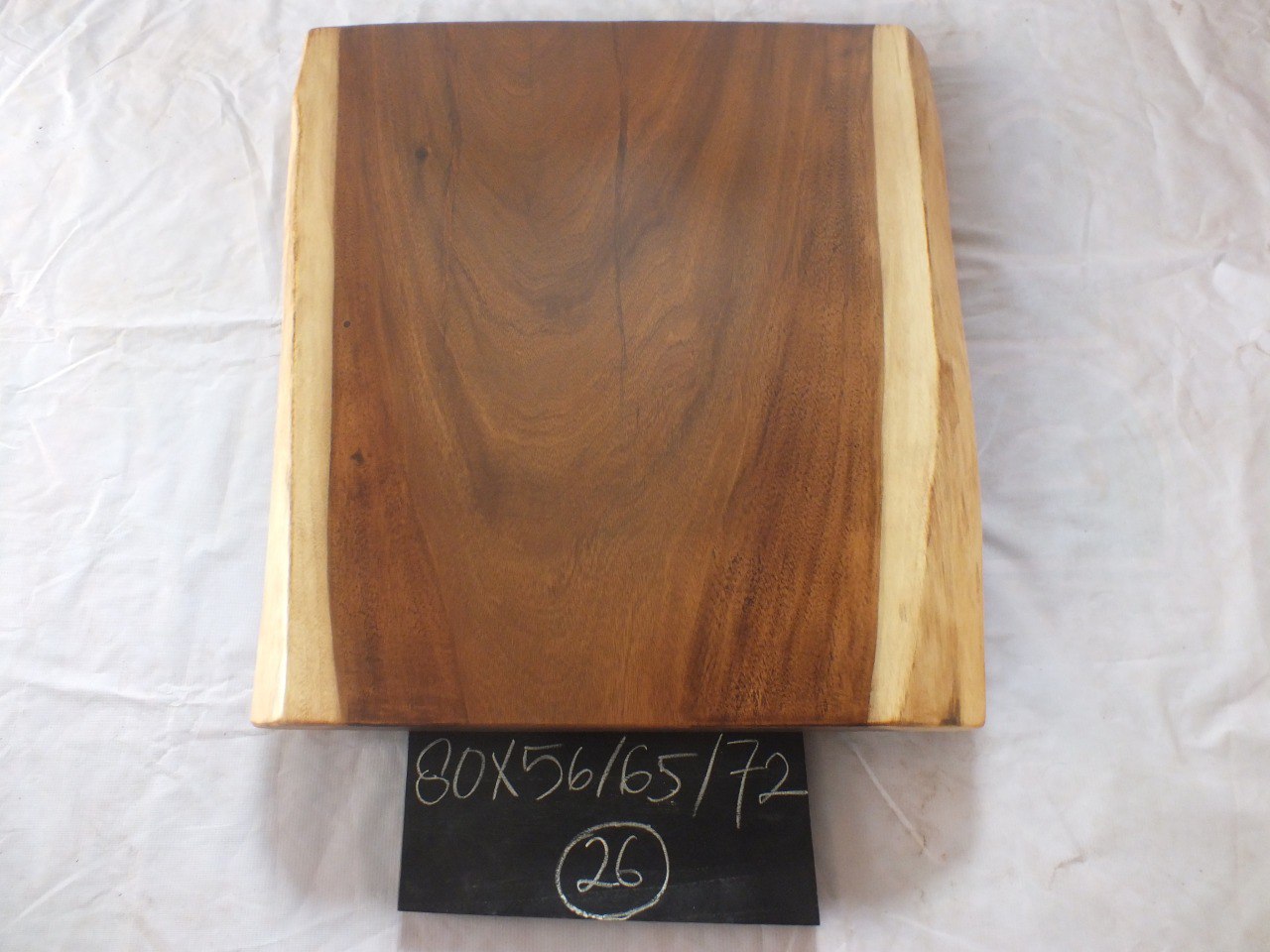 Top view of suar wood slab 0026-566572 with widening live edge shape and rich brown natural wood grain, solid single-piece countertop.
