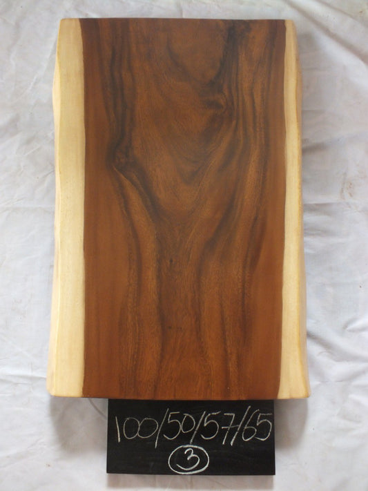 Top view of suar wood slab 0003-505765 with widening live edge shape and rich brown natural wood grain, solid single-piece countertop.
