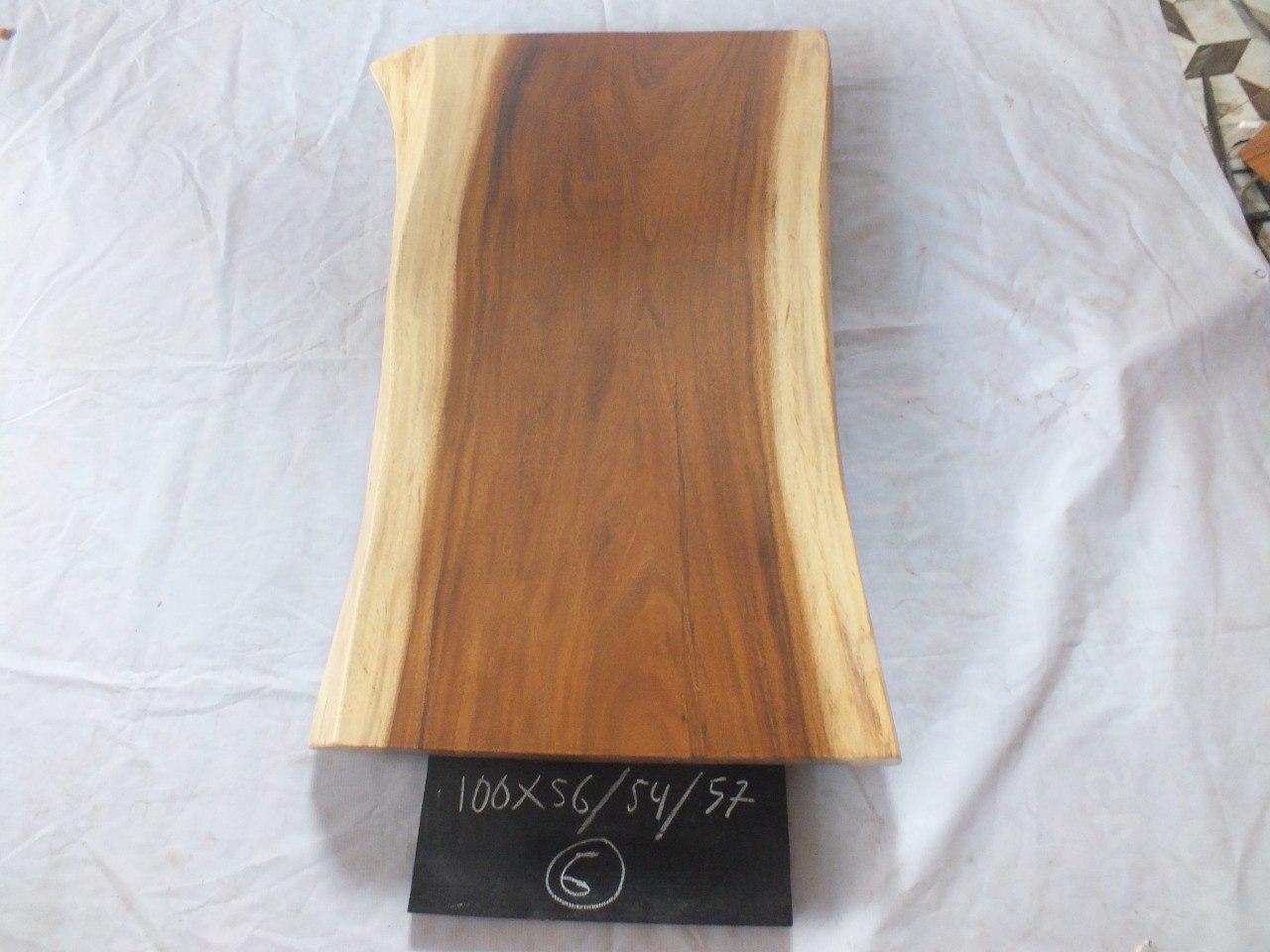 Top view of suar wood slab 0006-565457 with natural live edges and warm brown solid wood grain, single-piece hardwood countertop.
